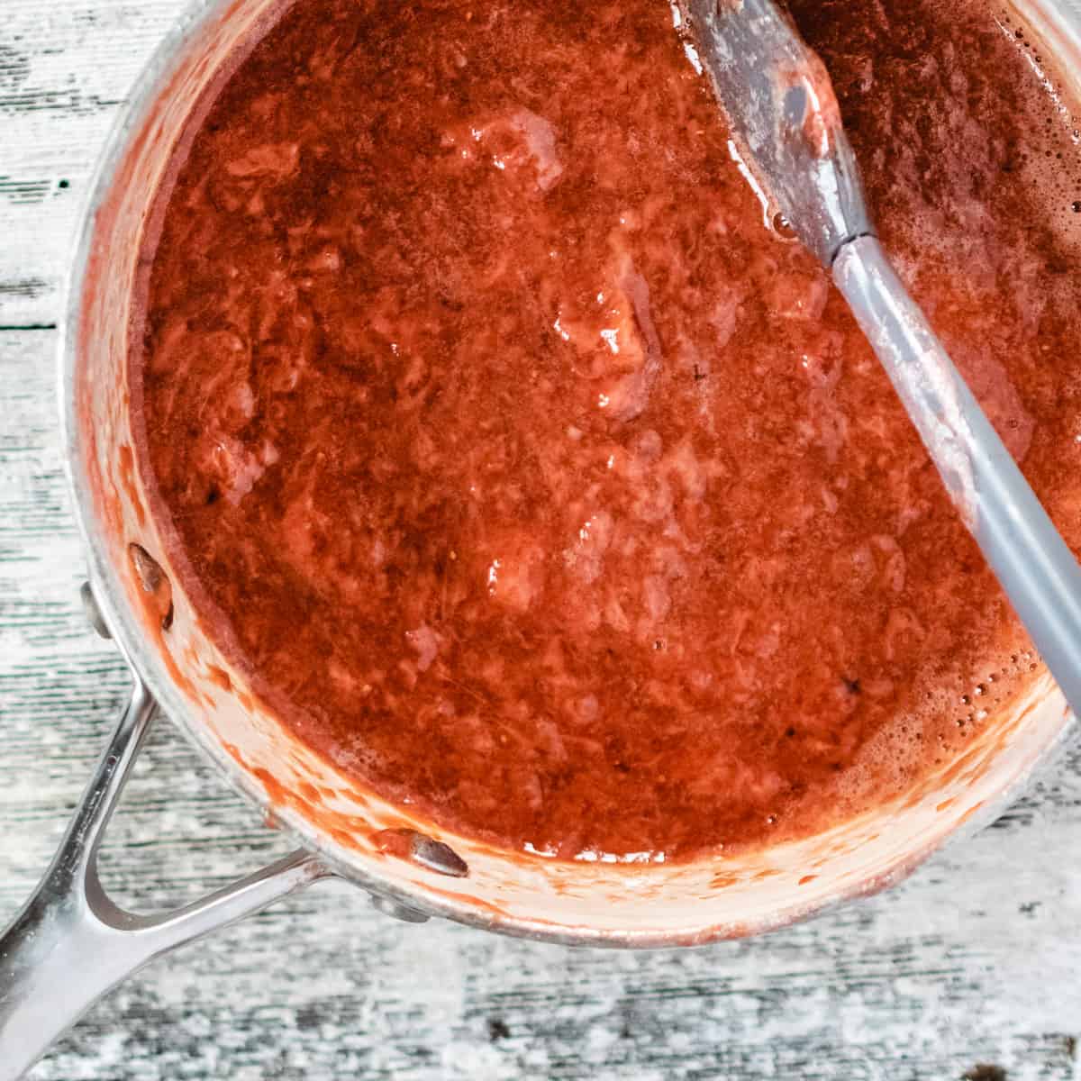 Sauce pan of pureed strawberry puree. 