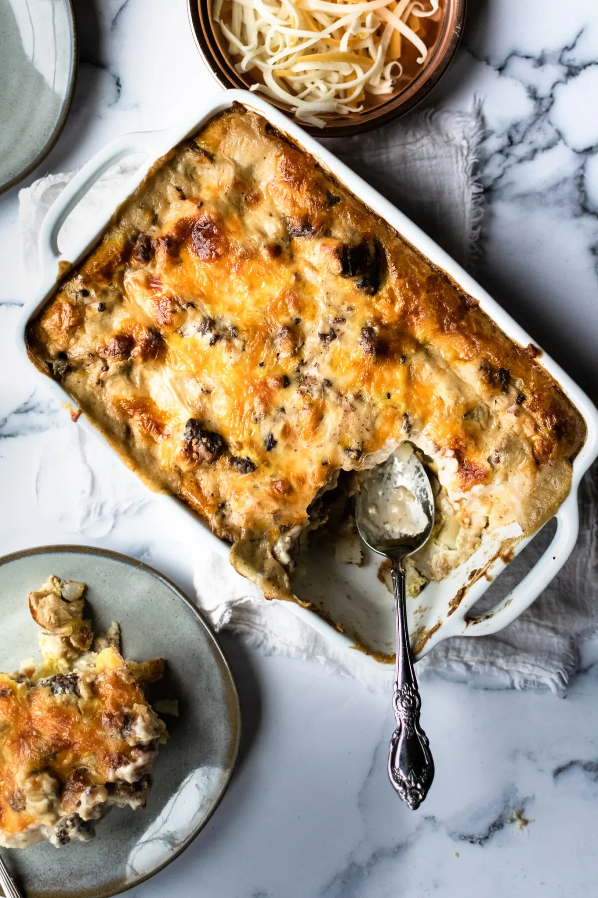 A scoop of sausage gravy breakfast casserole on a plate.