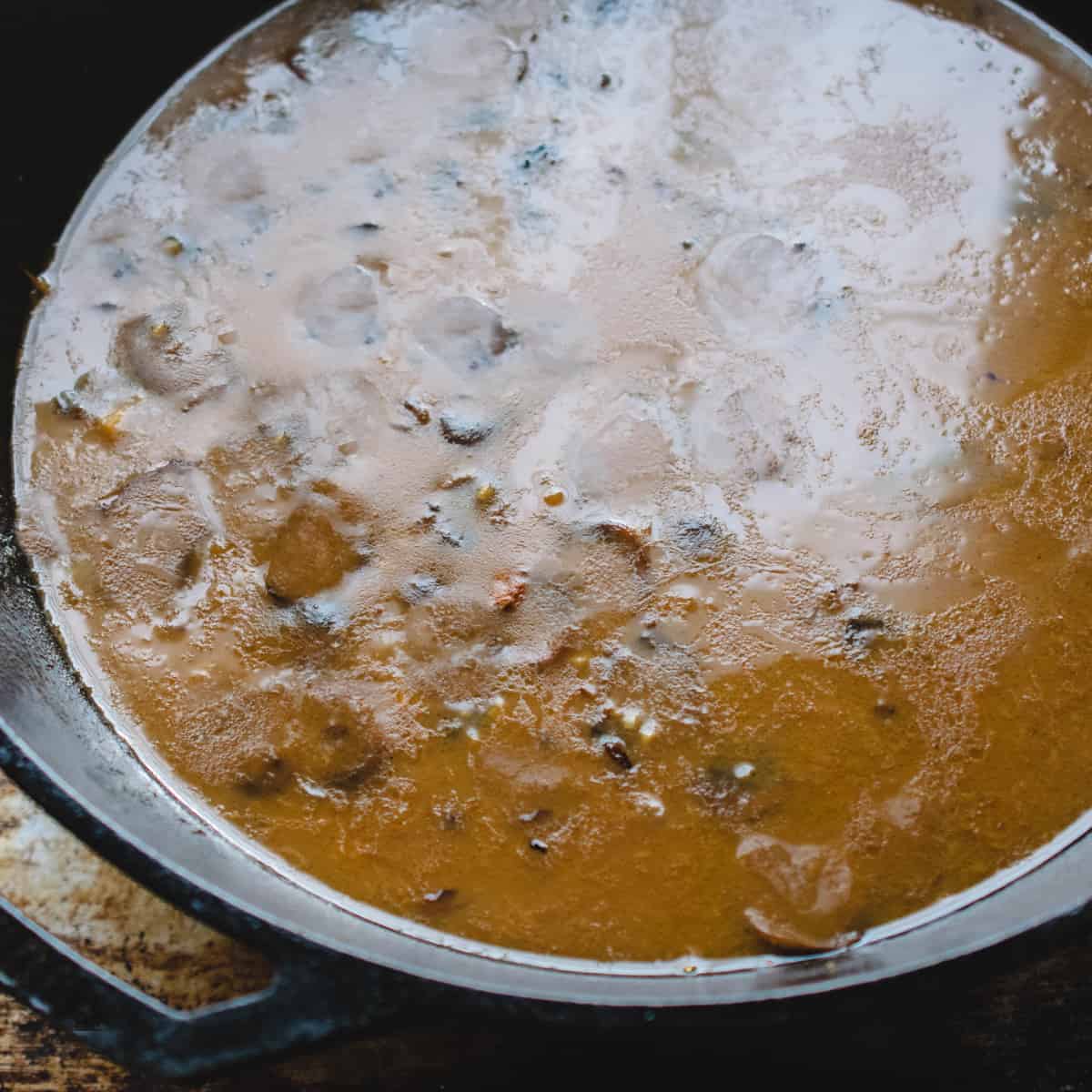 Mushroom pan sauce simmering in a pan. 