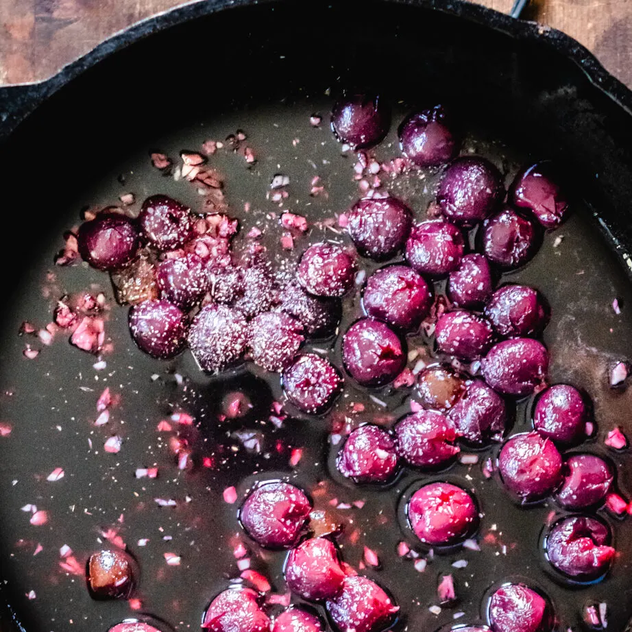 Skillet of cherry sauce with wine.