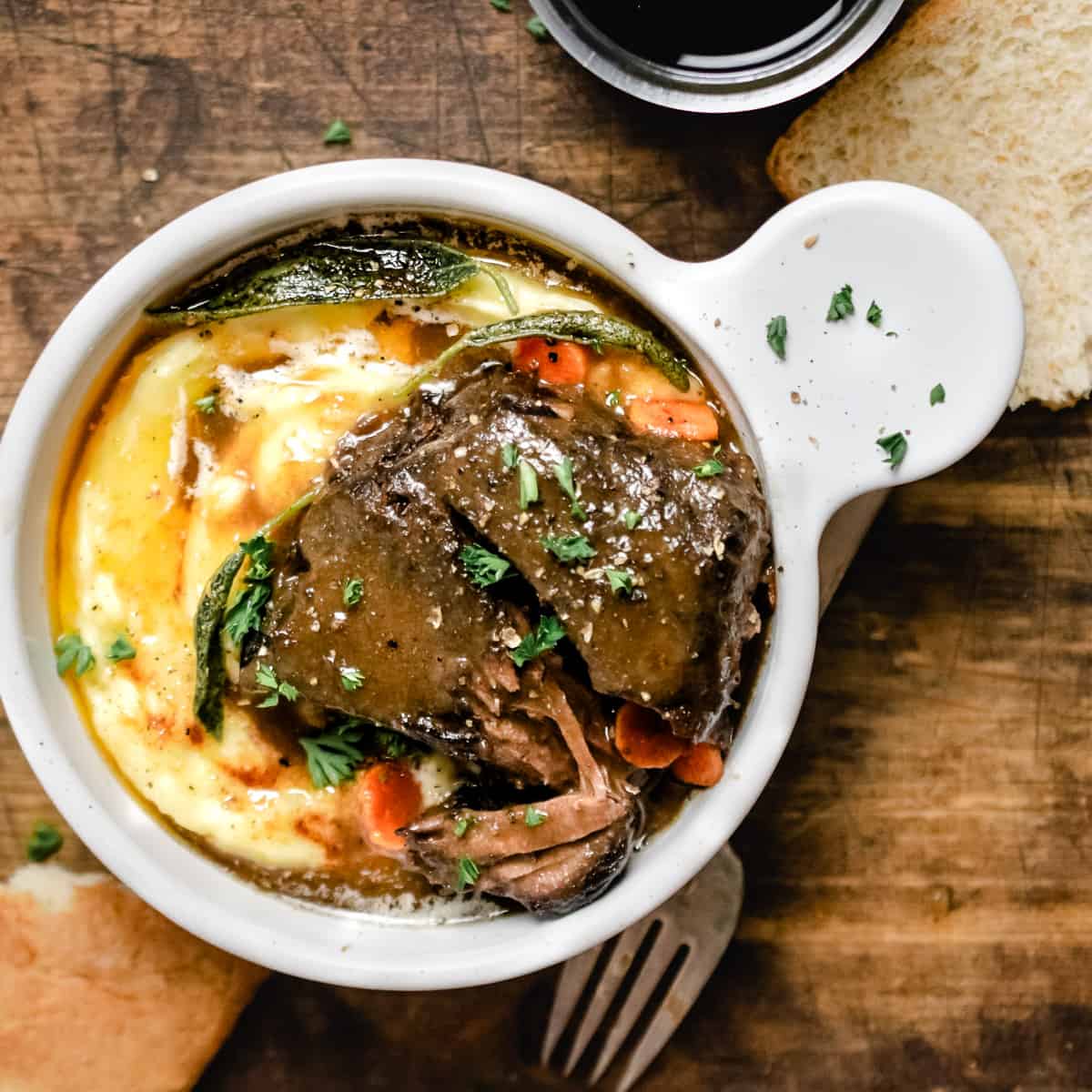 Bowl of mashed potatoes with braised beef and gravy. 