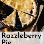 Sliced razzleberry pie in a pie pan with plates.