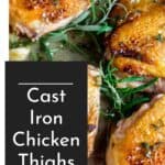 Crispy skin on chicken thighs in a cast iron skillet with herbs.