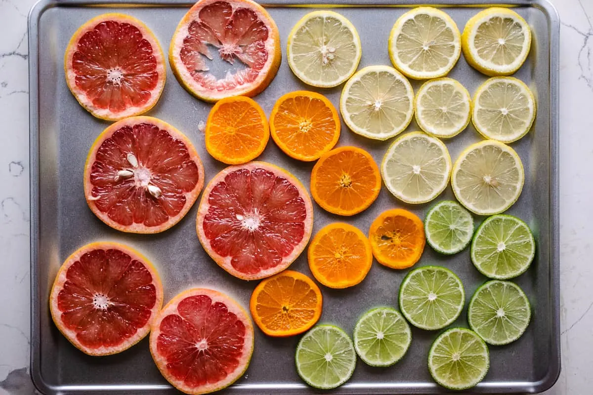 Sliced oranges, grapefruit and citrus on a baking sheet. 