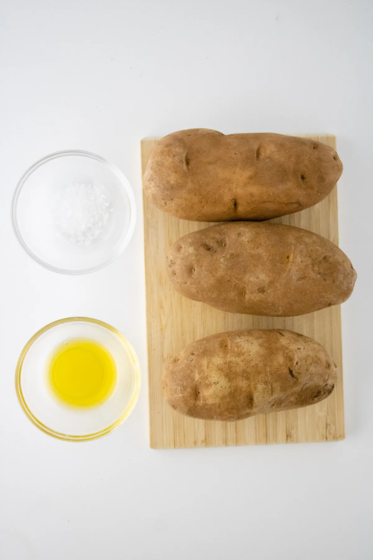 easy ingredients for air fryer baked potatoes, russet potatoes, salt, and oil