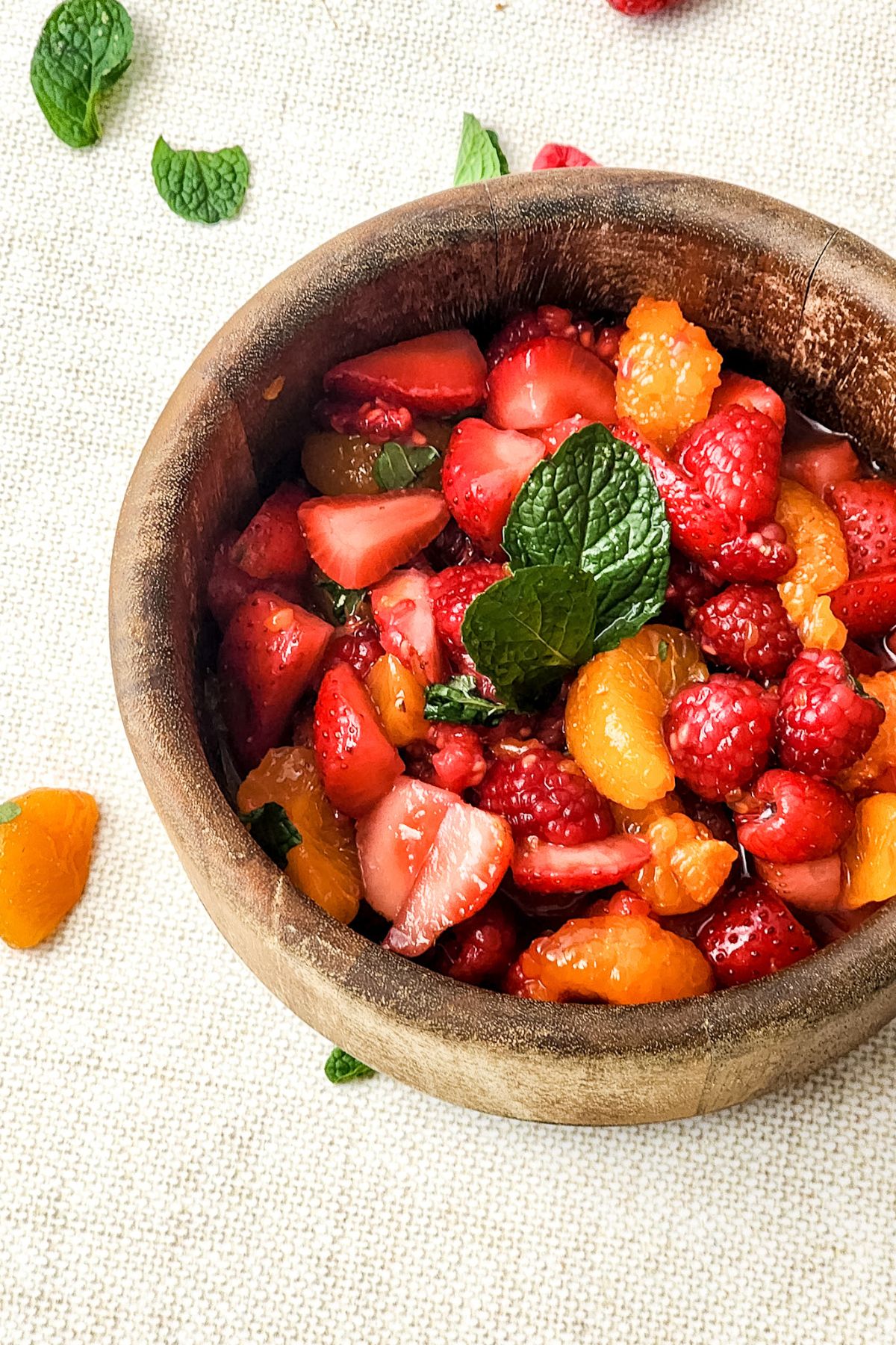 A wooden bowl of Berry Fruit Salad. 