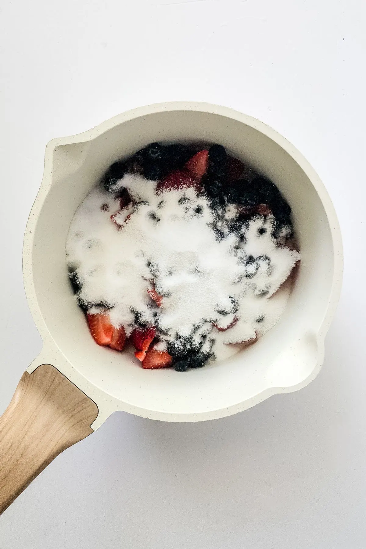 A skillet of berries and sugar.