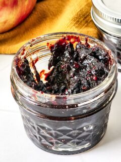 An open jar of Mixed Berry Jam.