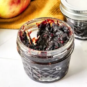 An open jar of Mixed Berry Jam.