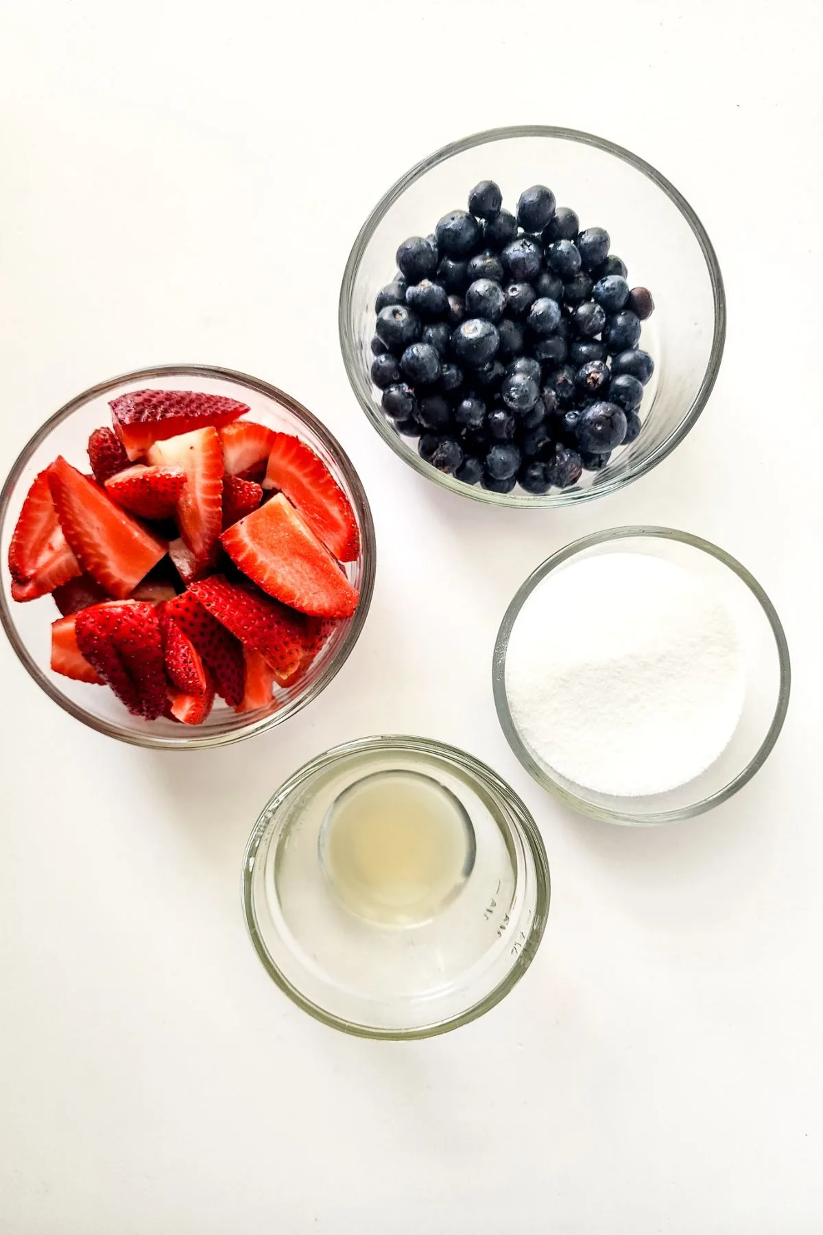 A few bowls of the ingredients needed to make Mixed Berry Jam.