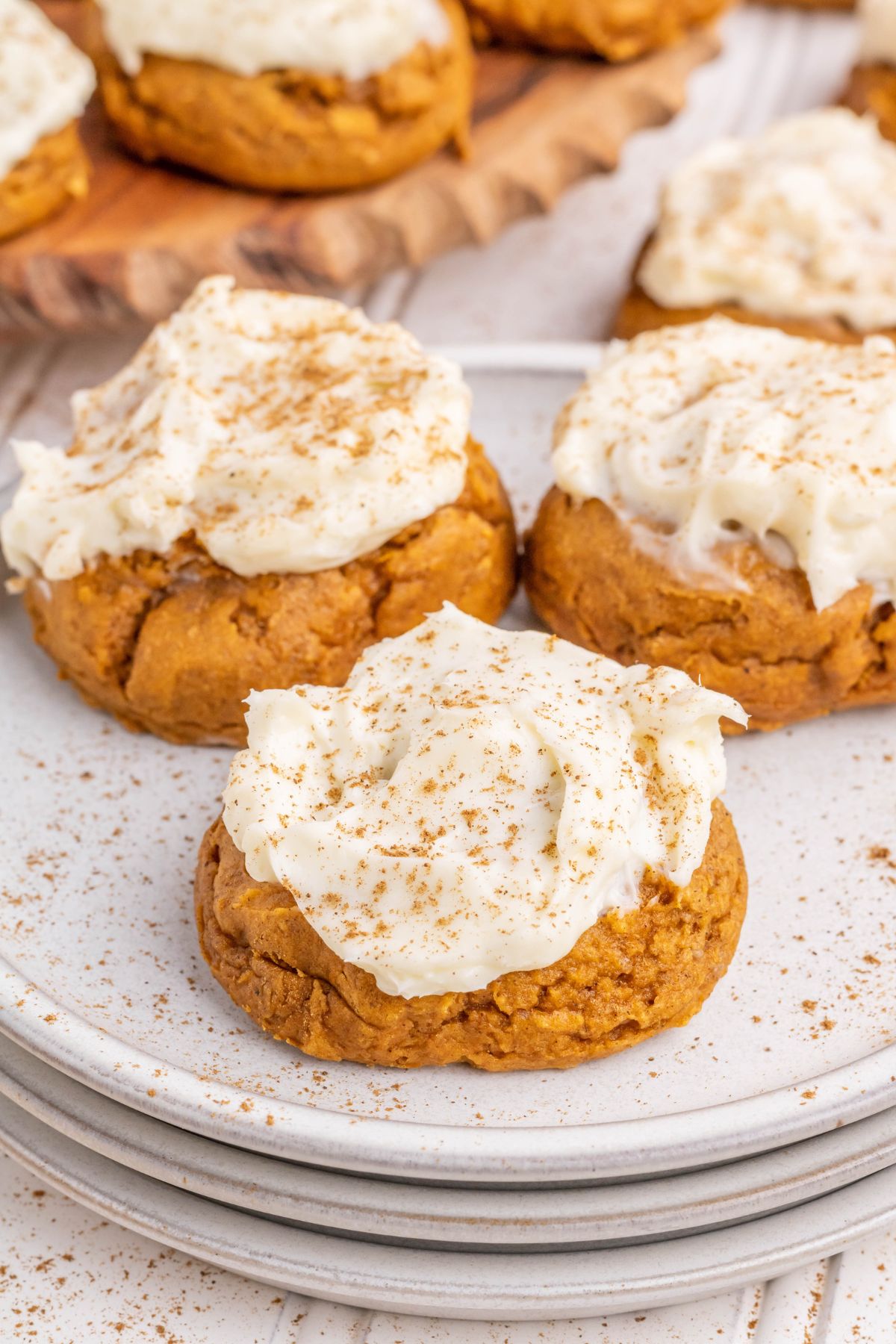 A white plate of homemade Pumpkin Cookies with frosting.