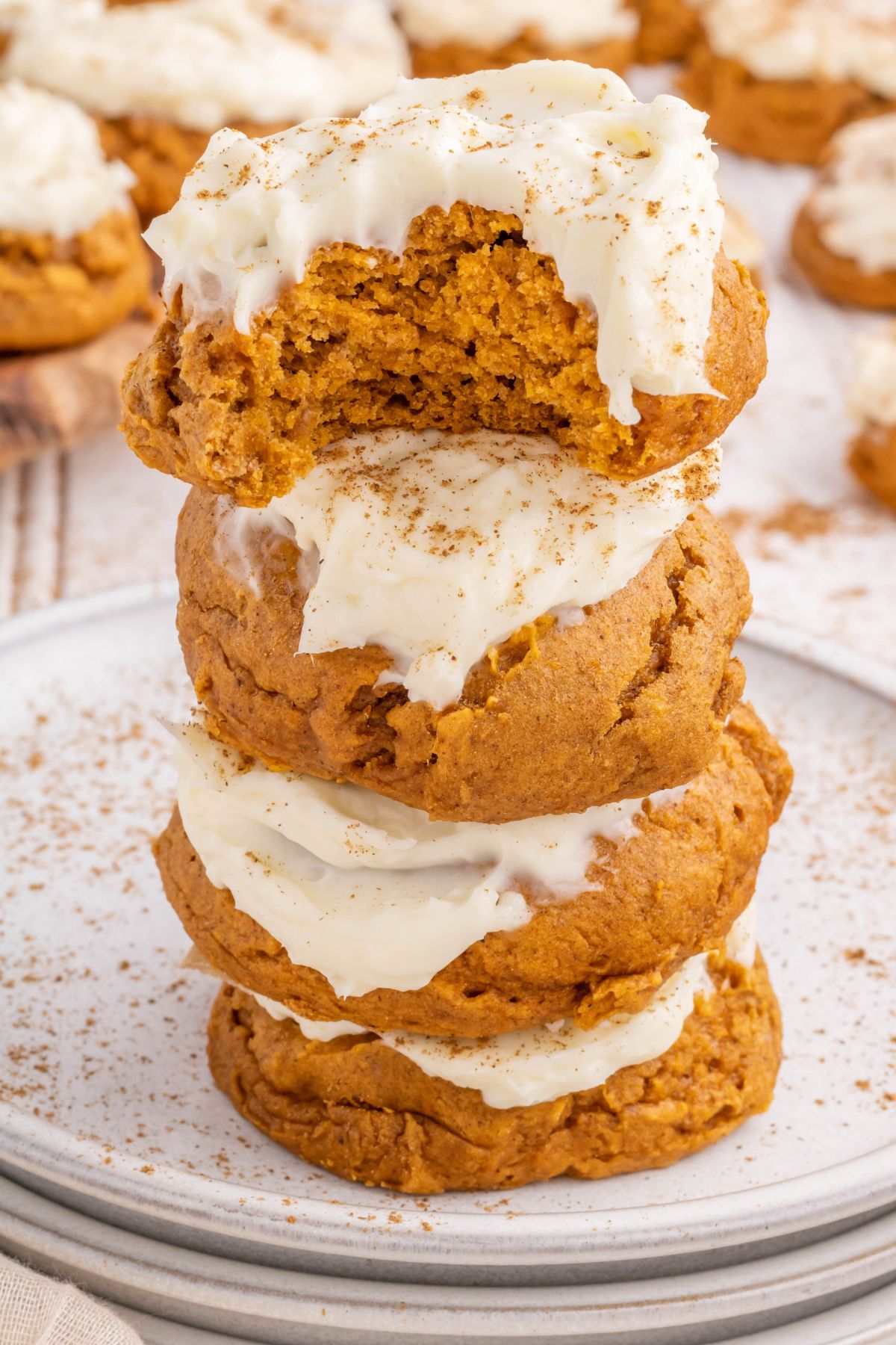 A tower of Pumpkin Cookies with the top one missing a bite.