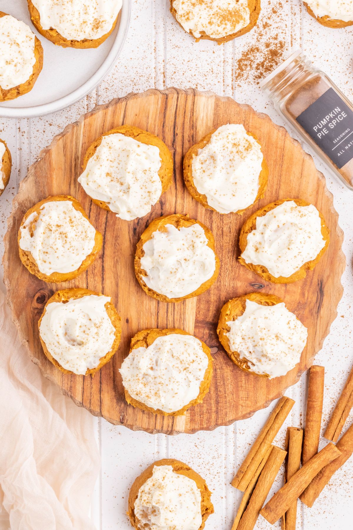 A plate of Pumpkin Cookies frosted with cream cheese frosting.