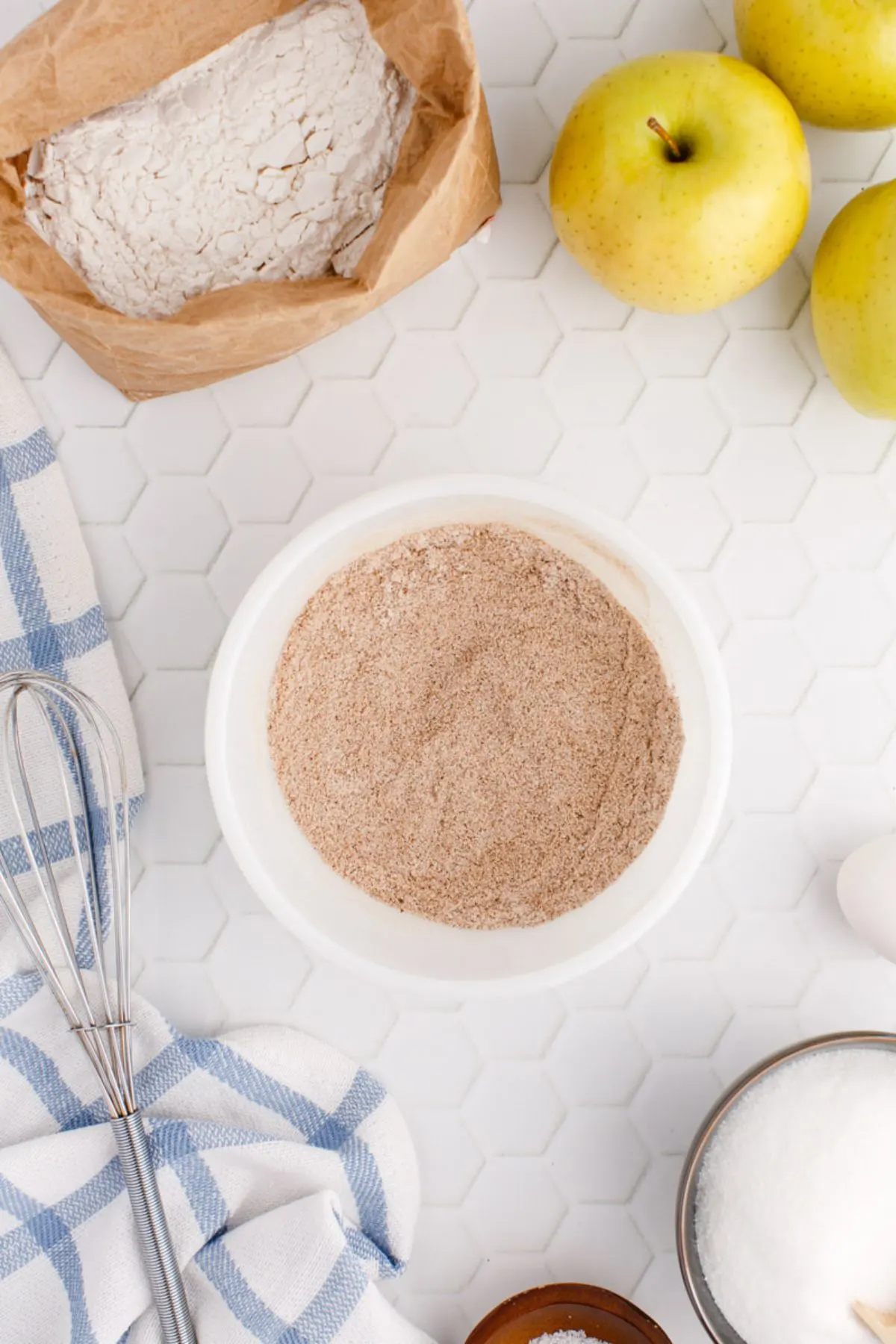 A bowl with sugar, corn starch, cinnamon, and cloves.