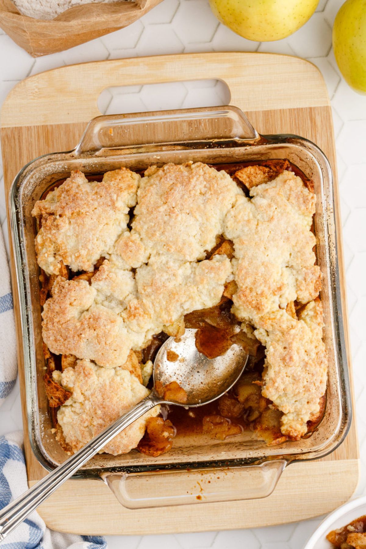 A baked Apple Cobbler with a serving removed.
