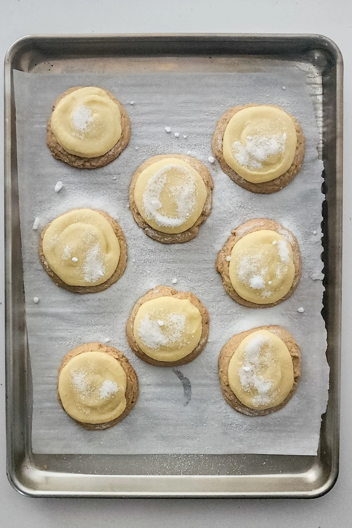 Cookies with creme and sugar on top.