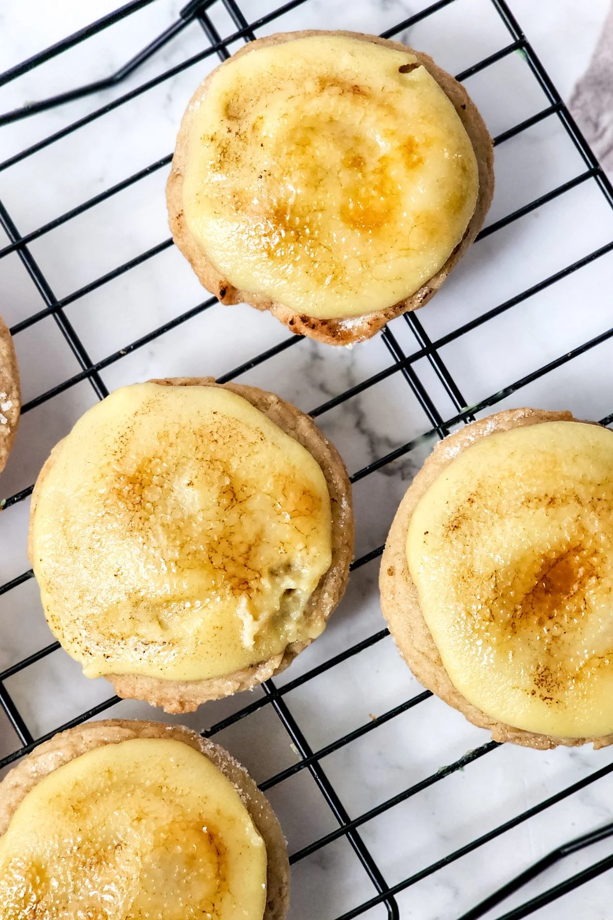 Looking down on a few Creme Brulee Cookies on a rack.