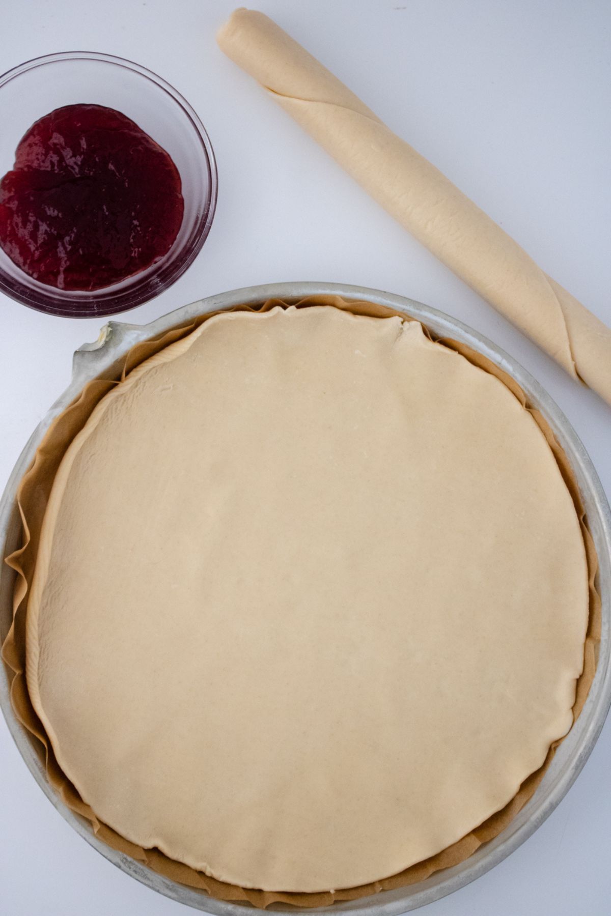 A rolled out pie crust in a pan.