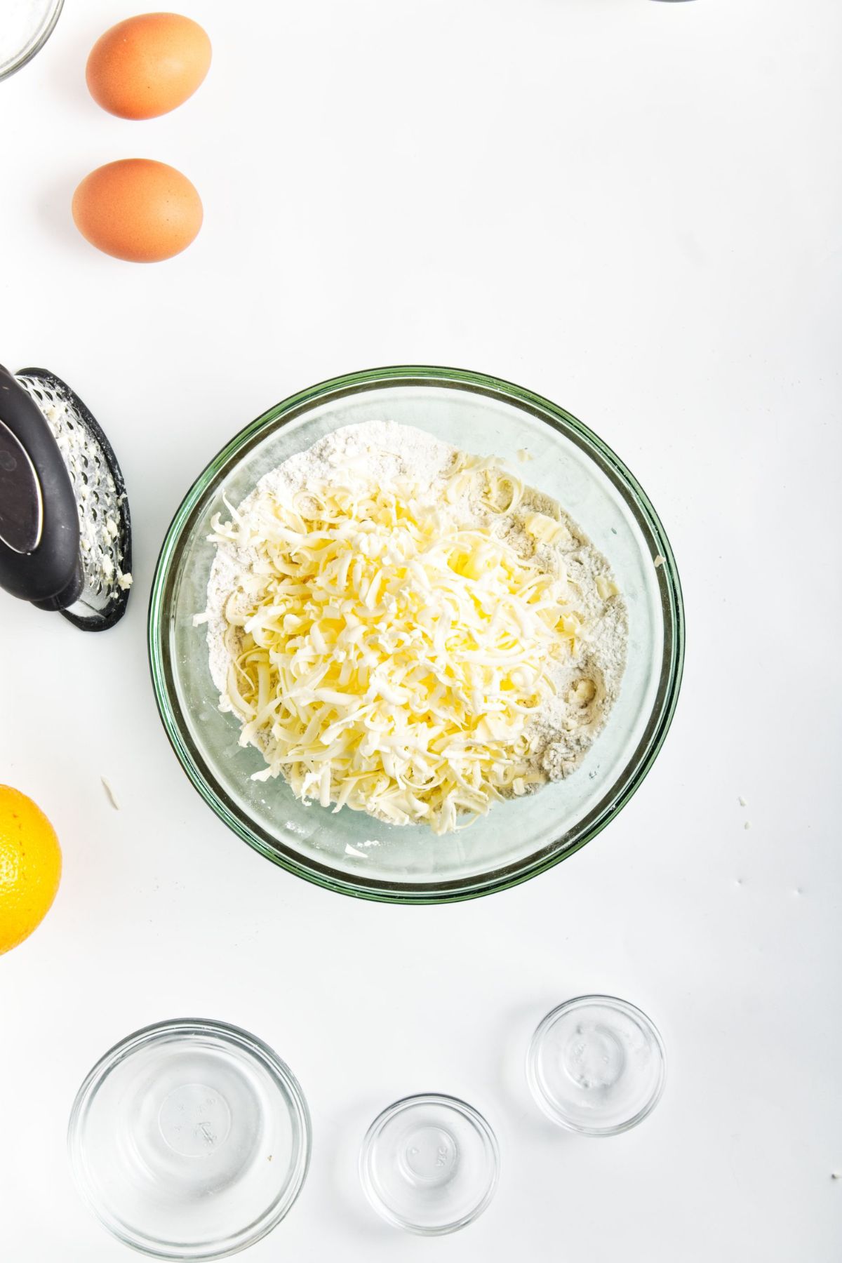 Dry ingredients with grated butter in a mixing bowl.