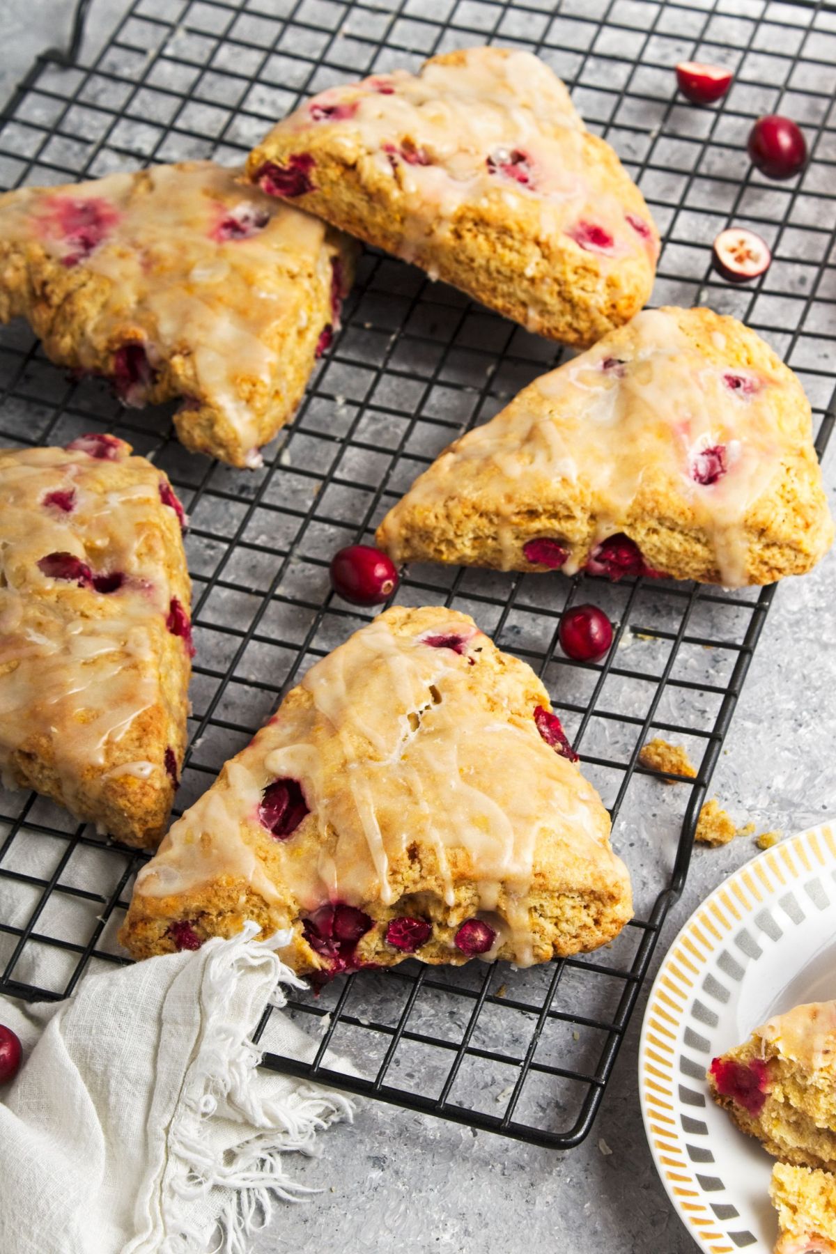 A few homemade Orange cranberry scones on a wire rack.