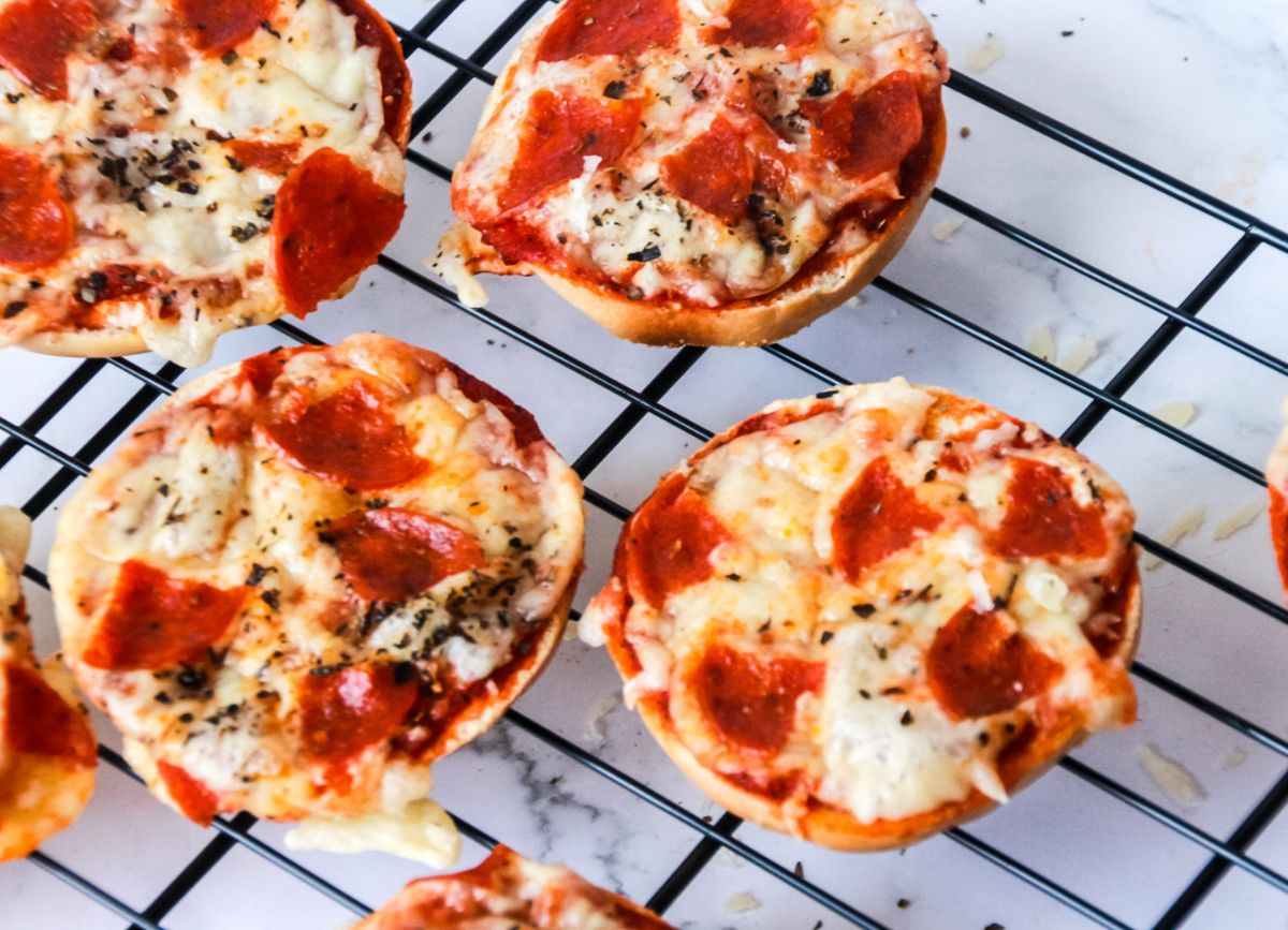 A wire rack with homemade Pizza Bagels.