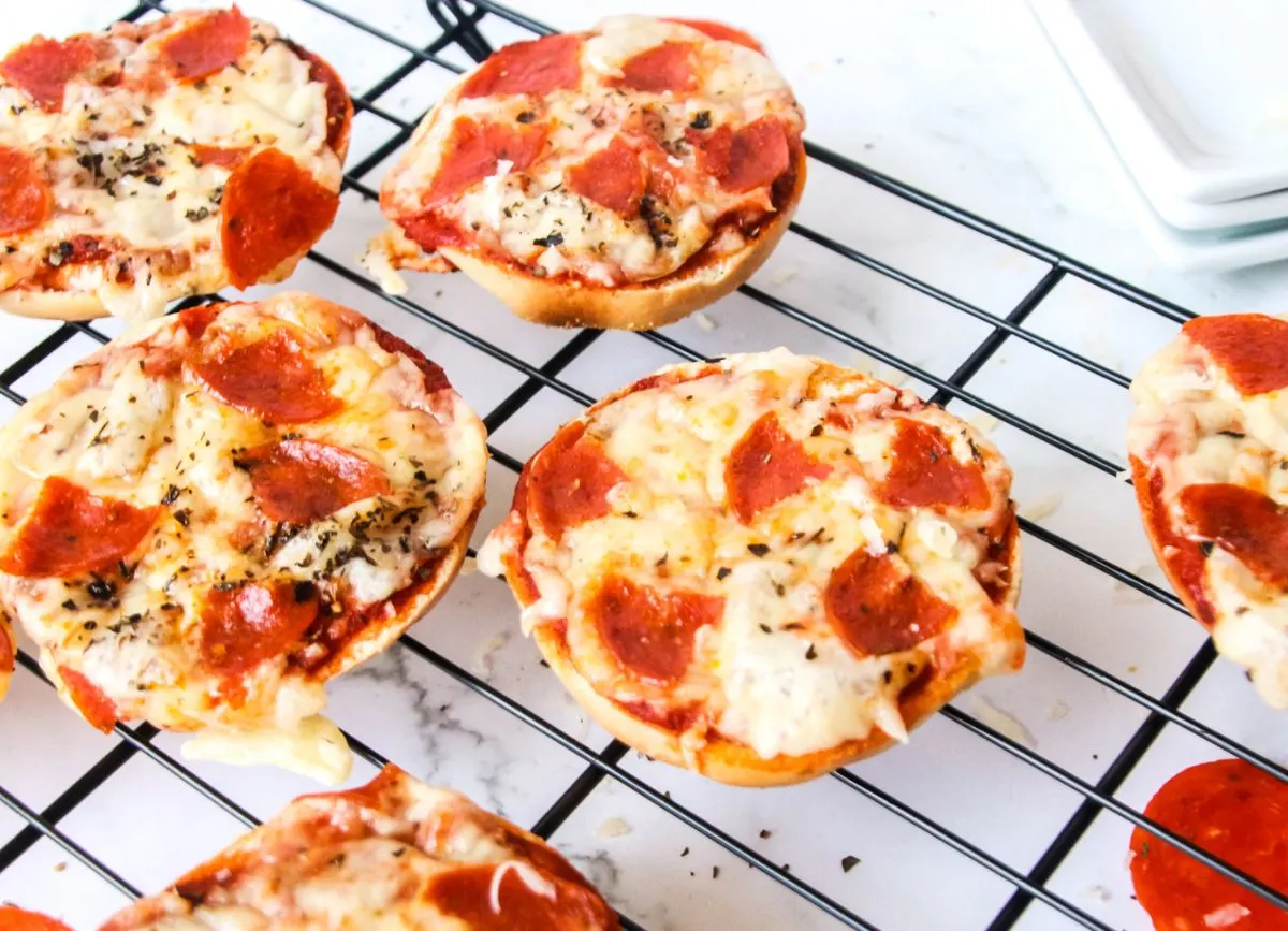 A bunch of Pizza Bagel Bites on a wire rack.